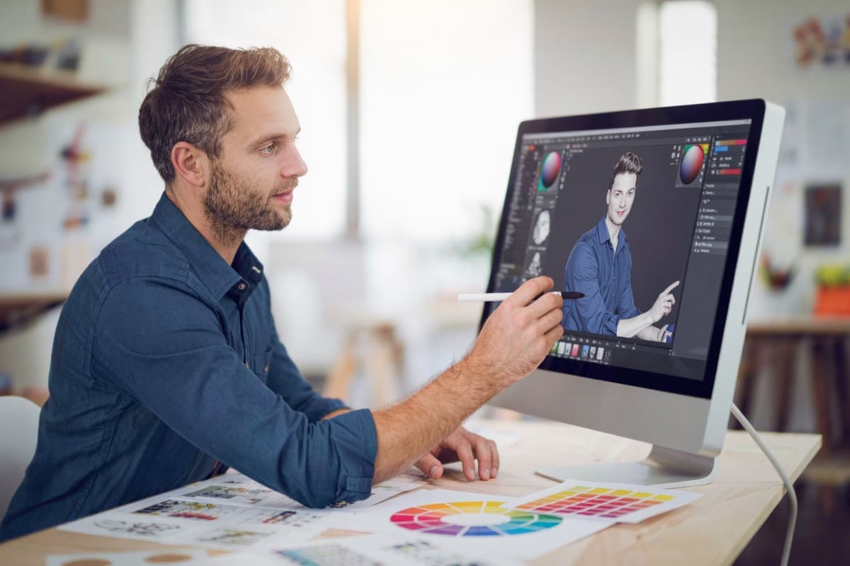 A designer laying out a brand palette on a desktop screen